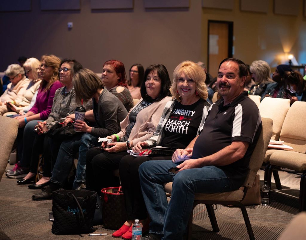 People smiling while attending a Marcus Wick Ministries event